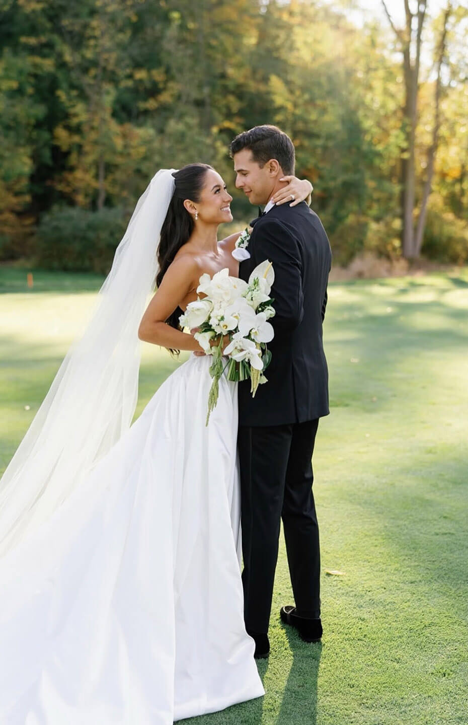 Сouple wearing a white gown and a black suit